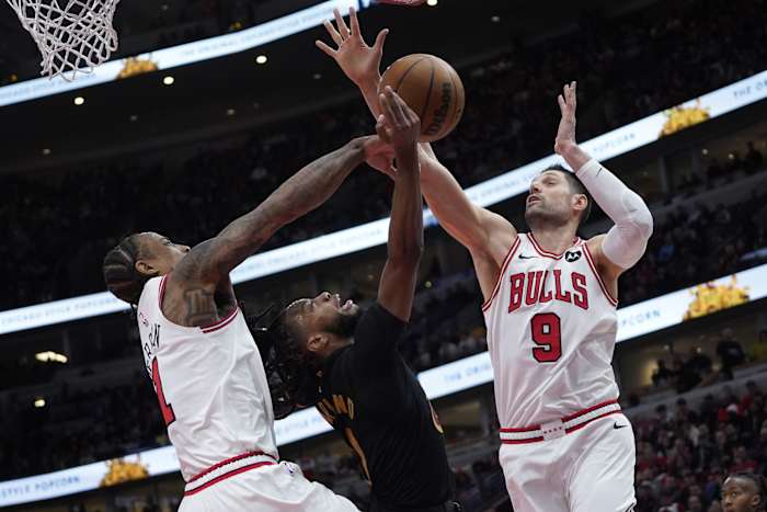 Chicago Bulls forward DeMar DeRozan (11) center Nikola Vucevic (9) defend Cleveland Cavaliers guard Darius Garland (10) during the second half at United Center.