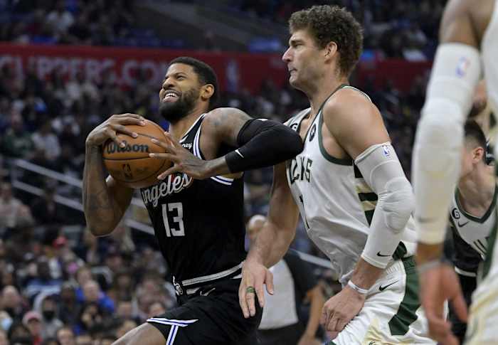 Los Angeles Clippers forward Paul George (13) drives past Milwaukee Bucks center Brook Lopez (11) i
