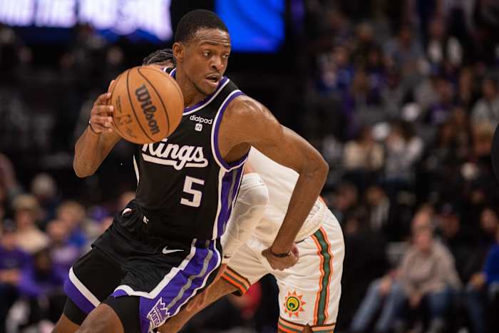 Feb 22, 2024; Sacramento, California, USA; Sacramento Kings guard De'Aaron Fox (5) dribbles past San Antonio Spurs guard Tre Jones (33) during the second quarter at Golden 1 Center. Mandatory Credit: Ed Szczepanski-USA TODAY Sports