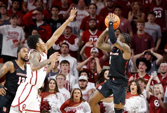 Houston Cougars guard Jamal Shead (1) shoots as Oklahoma Sooners forward Jalon Moore (14) defends during the second half at Lloyd Noble Center in Norman, Oklahoma, on March 2, 2024.