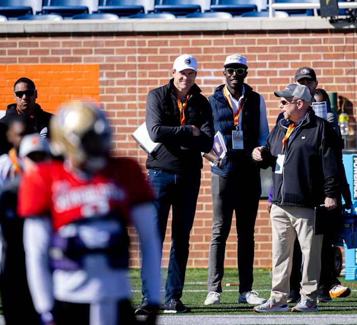 Kevin O'Connell and Kwesi Adofo-Mensah watch quarterback Michael Penix Jr. at the Senior Bowl in Mobile, Alabama.