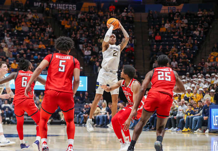 Mountaineers guard RaeQuan Battle (21) shoots a jumper over Texas Tech Red Raiders guard Kerwin Walton (24) during the second half at WVU Coliseum. Mandatory Credit: Ben Queen-USA TODAY Sports