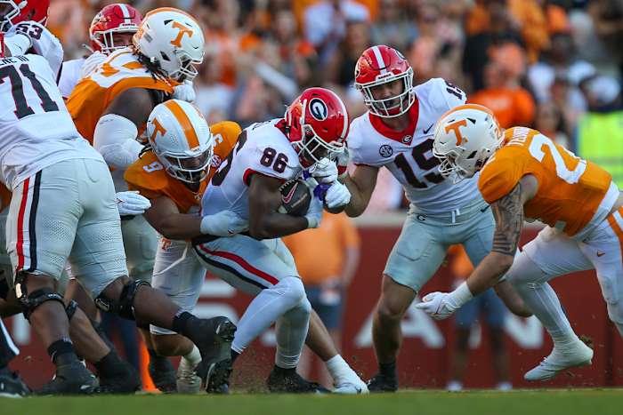 Nov 18, 2023; Knoxville, Tennessee, USA; Georgia Bulldogs wide receiver Dillon Bell (86) runs the ball against Tennessee Volunteers defensive lineman Tyler Baron (9) during the first half at Neyland Stadium. Mandatory Credit: Randy Sartin-USA TODAY Sports
