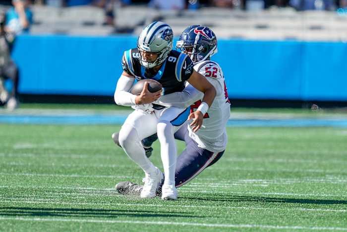 Panthers quarterback Bryce Young (9) is sacked by Houston Texans defensive end Jonathan Greenard (52) during the second half at Bank of America Stadium.