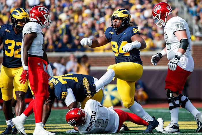 Michigan defensive lineman Kris Jenkins (94) celebrates a sack against UNLV quarterback Doug Brumfield (2) during the first half at Michigan Stadium in Ann Arbor on Saturday, Sept. 9, 2023.