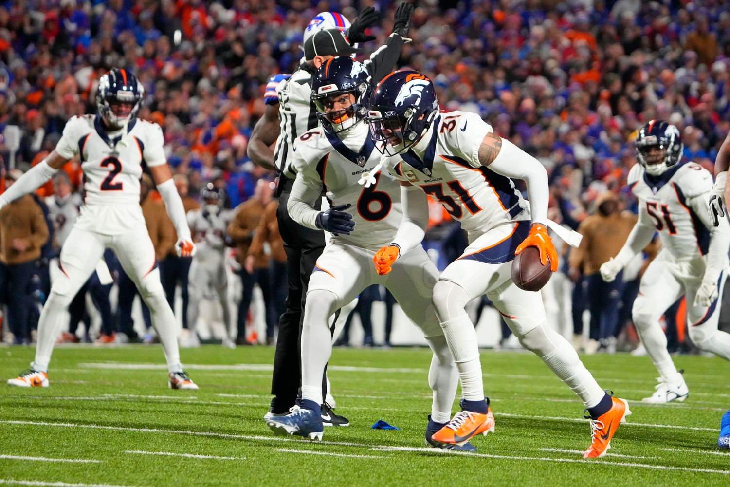 Broncos safety Justin Simmons (31) reacts after intercepting a pass with safety P.J. Locke (6) against the Buffalo Bills during the first half at Highmark Stadium.