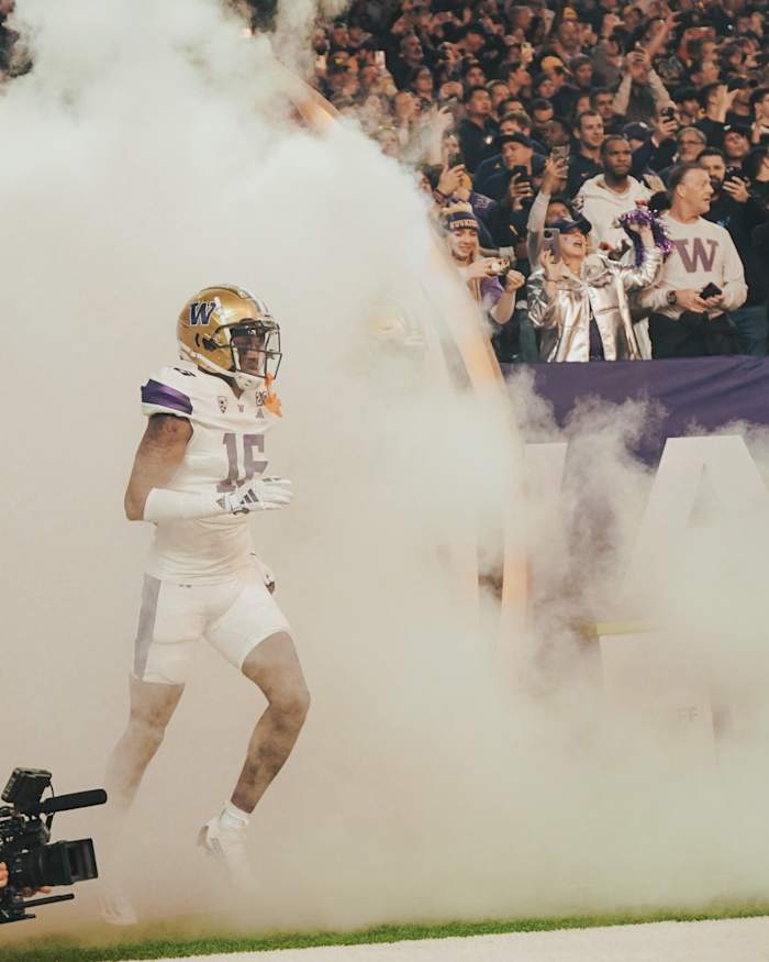 Curley Reed runs out on the field for the CFP title game in Houston.