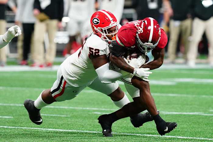 Dec 2, 2023; Atlanta, GA, USA; Georgia Bulldogs defensive lineman Christen Miller (52) tackles Alabama Crimson Tide running back Jam Miller (26) in the first quarter of the SEC Championship at Mercedes-Benz Stadium.