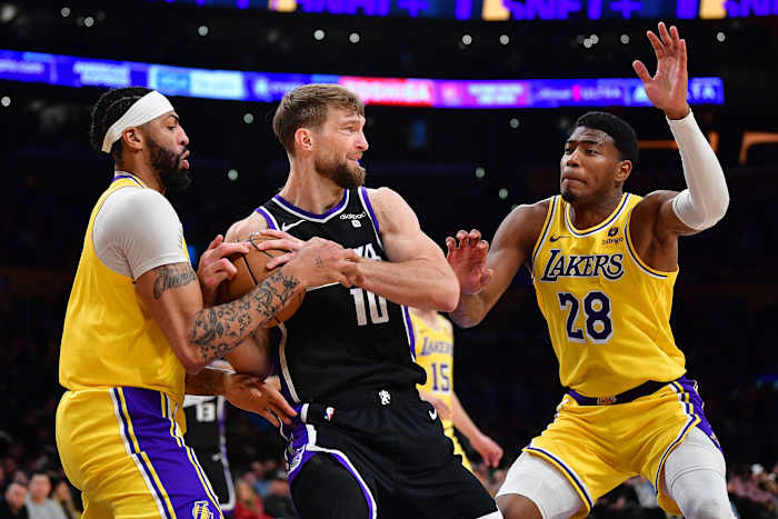Mar 6, 2024; Los Angeles, California, USA; Los Angeles Lakers forward Anthony Davis (3) and forward Rui Hachimura (28) play for the ball against Sacramento Kings forward Domantas Sabonis (10) during the first half at Crypto.com Arena. Mandatory Credit: Gary A. Vasquez-USA TODAY Sports