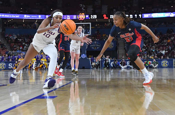 Louisiana State University forward Angel Reese (10) grabs a loose ball near Ole Miss guard Zakiya Stephenson (21) during the second quarter of the SEC Women's Basketball Tournament game at the Bon Secours Wellness Arena in Greenville, S.C. Saturday, March 9, 2024.