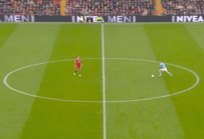 Erling Haaland pictured (right) running at Virgil van Dijk one-on-one during a Premier League game between Liverpool and Manchester City at Anfield in March 2024