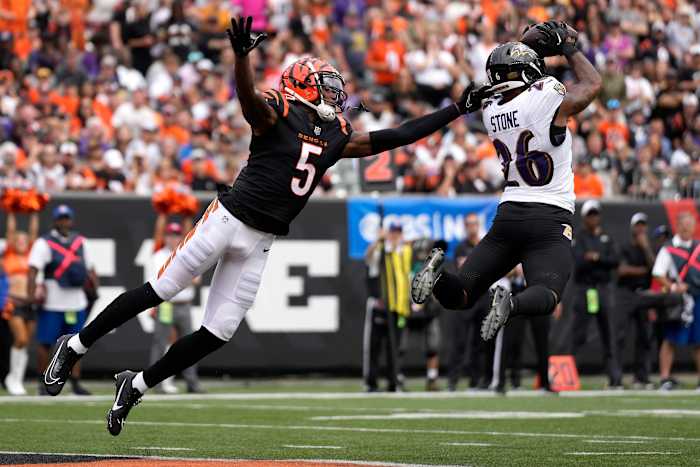 Baltimore Ravens safety Geno Stone (26) intercepts a pass intended for Cincinnati Bengals wide receiver Tee Higgins (5). © Sam Greene/The Enquirer / USA TODAY NETWORK