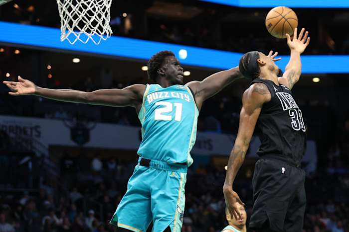 Brooklyn Nets center Nic Claxton (33) gets blocked by Charlotte Hornets forward JT Thor (21) during the third quarter at Spectrum Center.