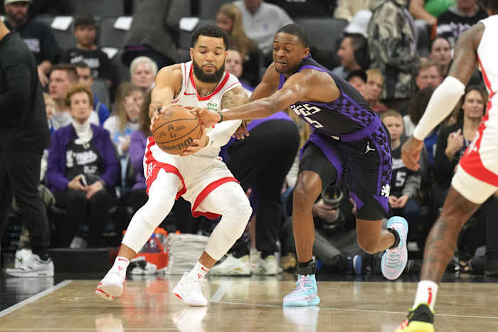 Kings guard De'Aaron Fox (right) reaches for a pass to Houston Rockets guard Fred VanVleet (left) during the first quarter at Golden 1 Center.