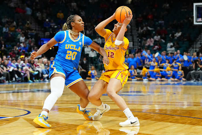 USC guard JuJu Watkins (12) protects the ball from UCLA guard Charisma Osborne (20) during the semifinals of the Pac-12 tournament.