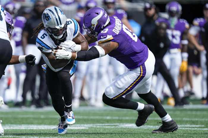 Oct 1, 2023; Charlotte, North Carolina, USA; Carolina Panthers place kicker Eddy Pineiro (4) is tackled by Minnesota Vikings linebacker Marcus Davenport (0) during the second half at Bank of America Stadium.