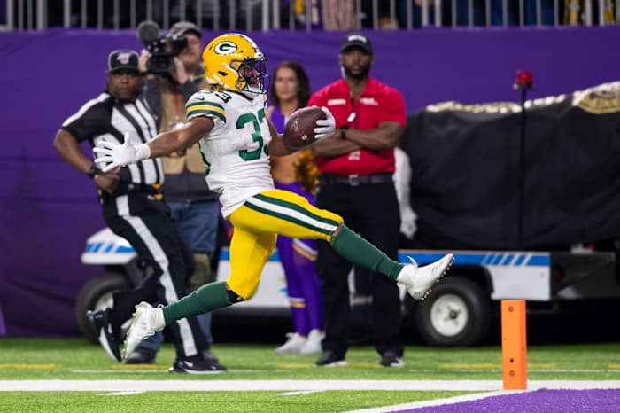 Dec 23, 2019; Minneapolis, Minnesota, USA; Green Bay Packers running back Aaron Jones (33) rushes for a touchdown in the fourth quarter against Minnesota Vikings at U.S. Bank Stadium.