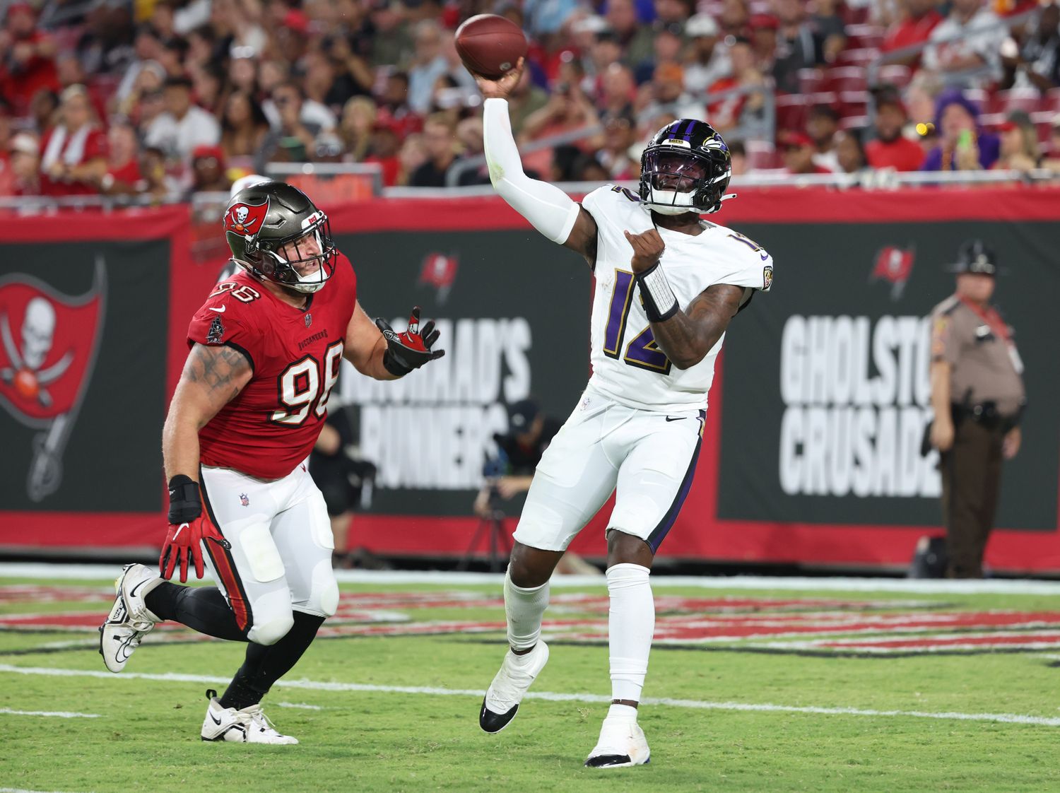 Baltimore Ravens quarterback Anthony Brown (12) throws the ball as Tampa Bay Buccaneers defensive tackle Greg Gaines (96) defends during the second quarter at Raymond James Stadium. Mandatory Credit: Kim Klement Neitzel-USA TODAY Sports