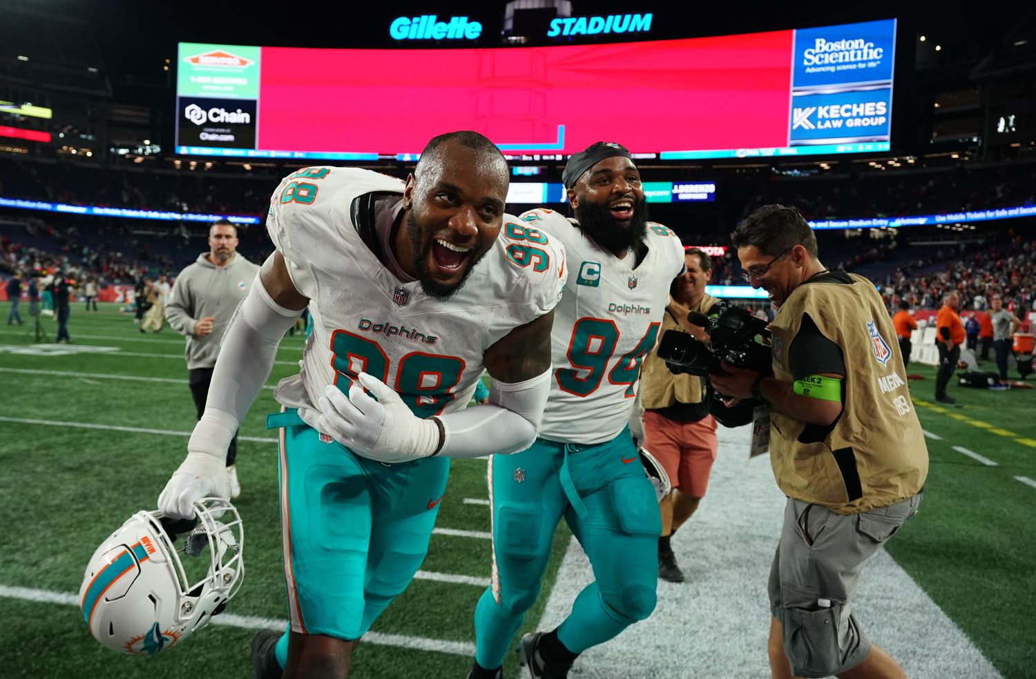 Sep 17, 2023; Foxborough, Massachusetts, USA; Miami Dolphins defensive tackle Raekwon Davis (98) and defensive tackle Christian Wilkins (94) react after defeating the New England Patriots at Gillette Stadium. Mandatory Credit: David Butler II-USA TODAY Sports