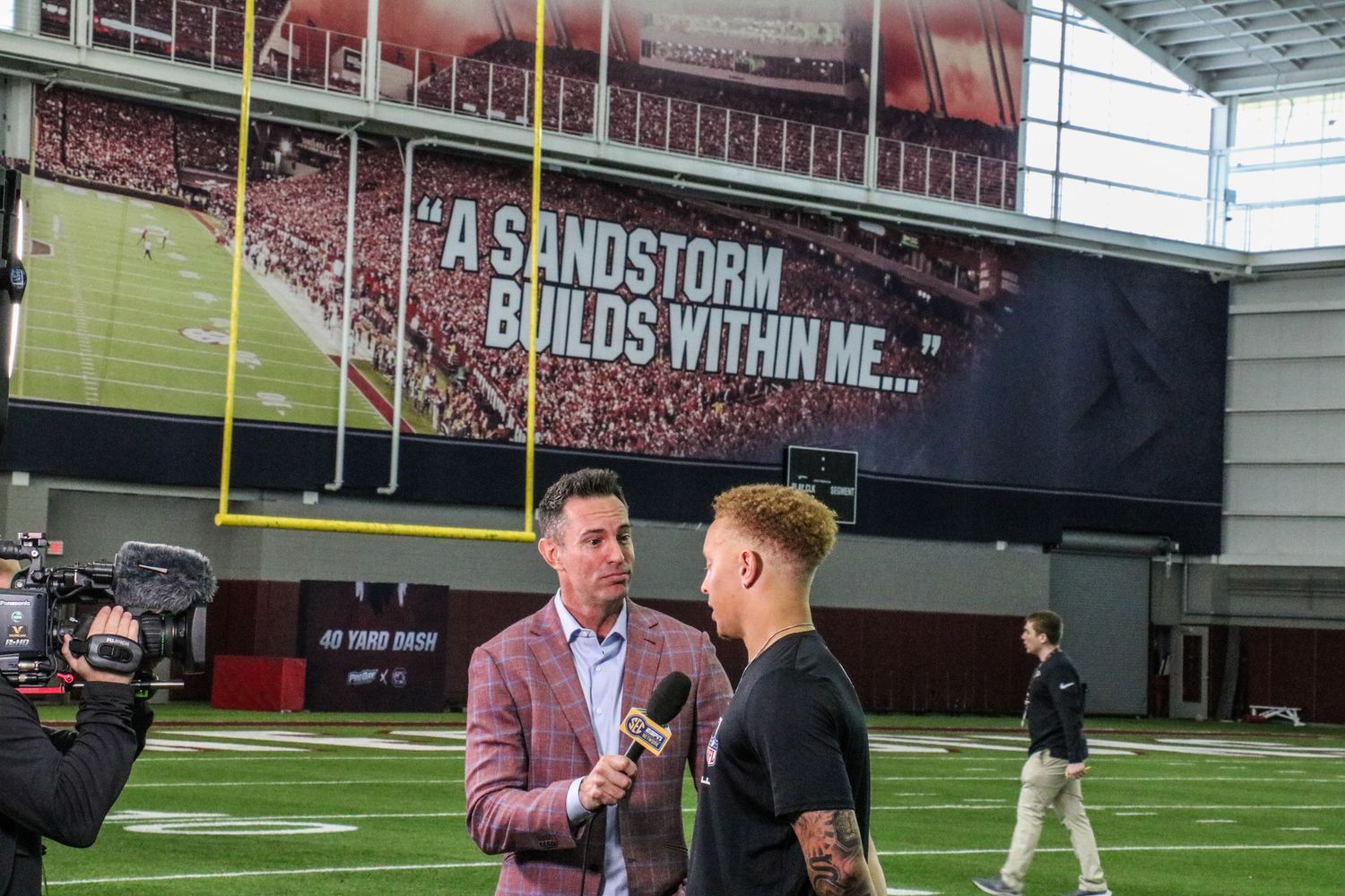 SEC Network's Peter Burns talks to Spencer Rattler after his workout