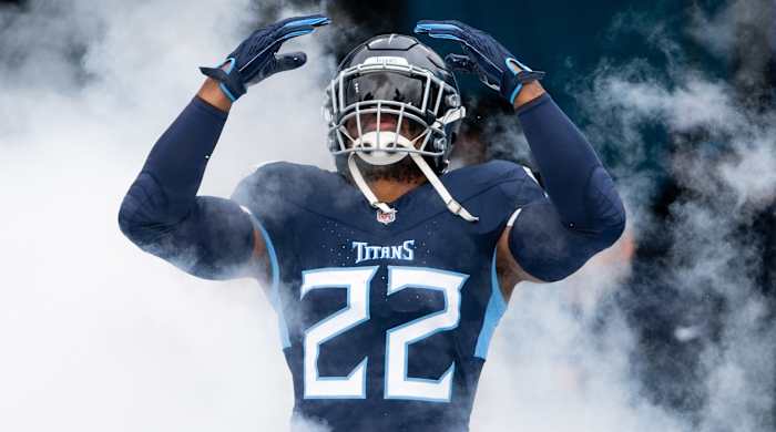 Derrick Henry runs out of a cloud of smoke