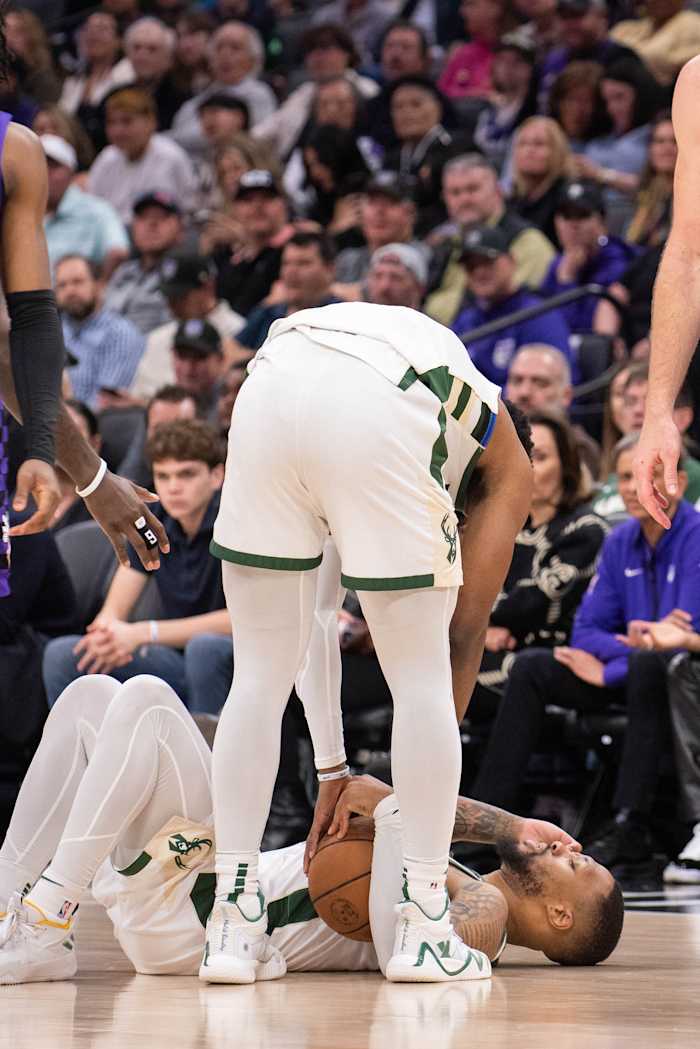 Milwaukee Bucks guard Damian Lillard (0) lays on the floor