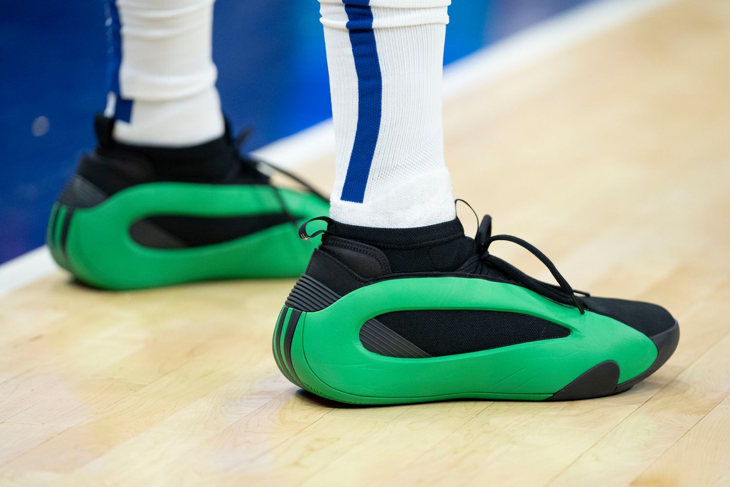 Los Angeles Clippers guard James Harden's green and black adidas sneakers.