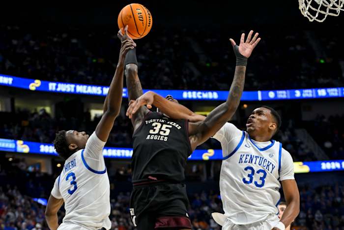Mar 15, 2024; Nashville, TN, USA; Kentucky Wildcats forward Ugonna Onyenso (33) and guard Adou Thiero (3) block the shot of Texas A&M Aggies guard Manny Obaseki (35) during the first half at Bridgestone Arena. Mandatory Credit: Steve Roberts-USA TODAY Sports