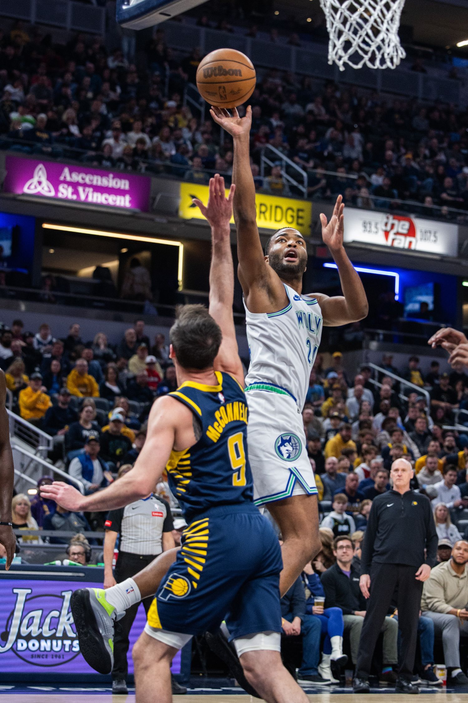 Minnesota Timberwolves forward TJ Warren (24) shoots the ball while Indiana Pacers guard T.J. McConnell (9) defends during the first half at Gainbridge Fieldhouse in Indianapolis on March 7, 2024.