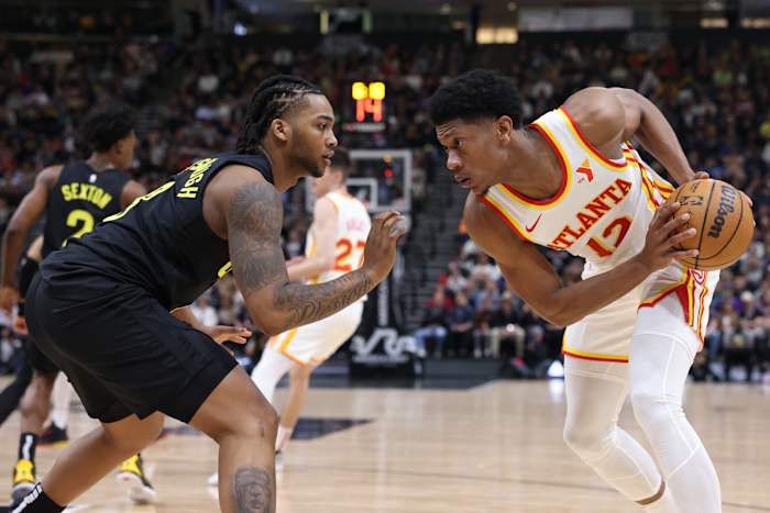 Mar 15, 2024; Salt Lake City, Utah, USA; Atlanta Hawks forward De'Andre Hunter (12) looks to move the ball against Utah Jazz forward Brice Sensabaugh (8) during the second quarter at Delta Center. Mandatory Credit: Rob Gray-USA TODAY Sports
