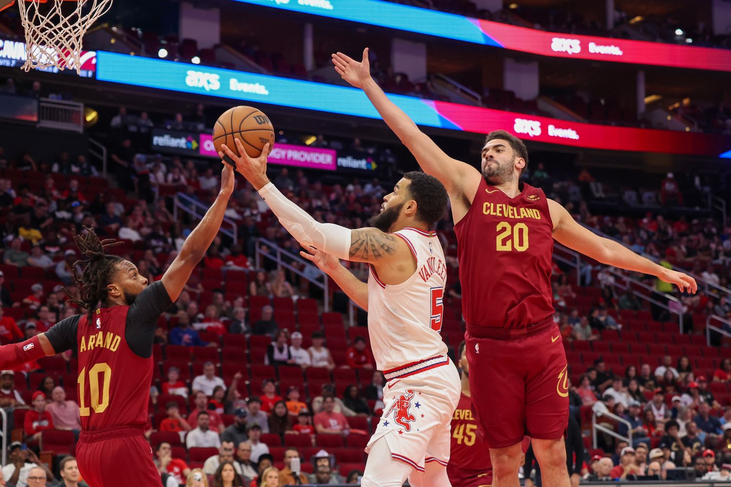 Mar 16, 2024; Houston, Texas, USA; Houston Rockets guard Fred VanVleet (5) splits the defense of Cleveland Cavaliers guard Darius Garland (10) and forward Georges Niang (20) in the first quarter at Toyota Center. Mandatory Credit: Thomas Shea-USA TODAY Sports