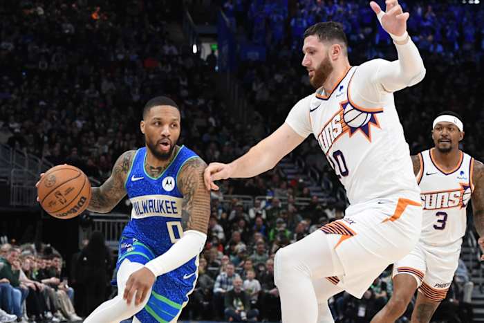 Milwaukee Bucks guard Damian Lillard (0) drives against Phoenix Suns center Jusuf Nurkic (20)