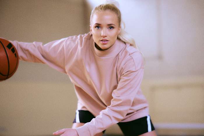 Hailey Van Lith dribbles a basketball in an adidas photo shoot.