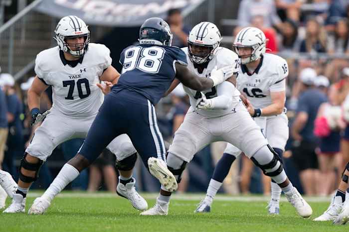 Yale Bulldogs offensive lineman Kiran Amegadjie (72) blocks Connecticut Huskies defensive lineman Lwal Uguak (98) during the first half at Rentschler Field at Pratt & Whitney Stadium.