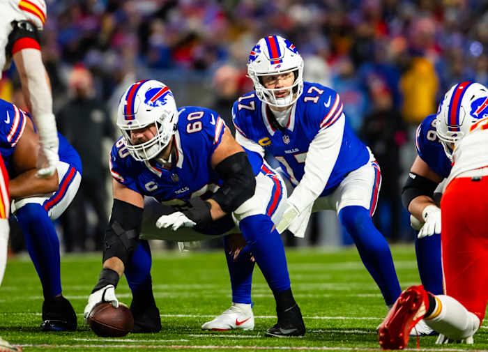 Mitch Morse bends over to snap the ball to Josh Allen
