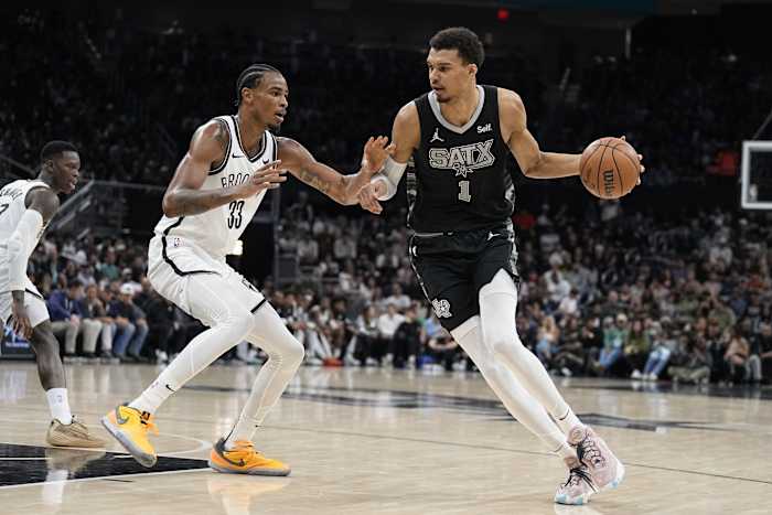 San Antonio Spurs forward Victor Wembanyama (1) drives to the basket while defended by Brooklyn Nets center Nicolas Claxton (33)