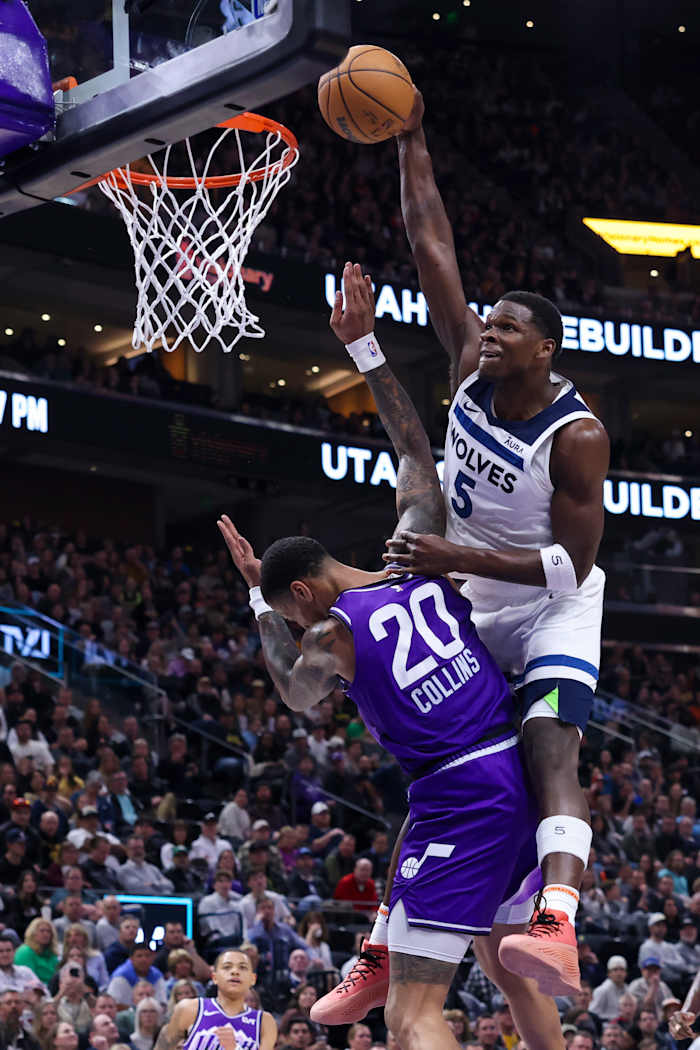 Minnesota Timberwolves guard Anthony Edwards (5) dunks the ball against Utah Jazz forward John Collins (20) during the third quarter at Delta Center in Salt Lake City on March 18, 2024.