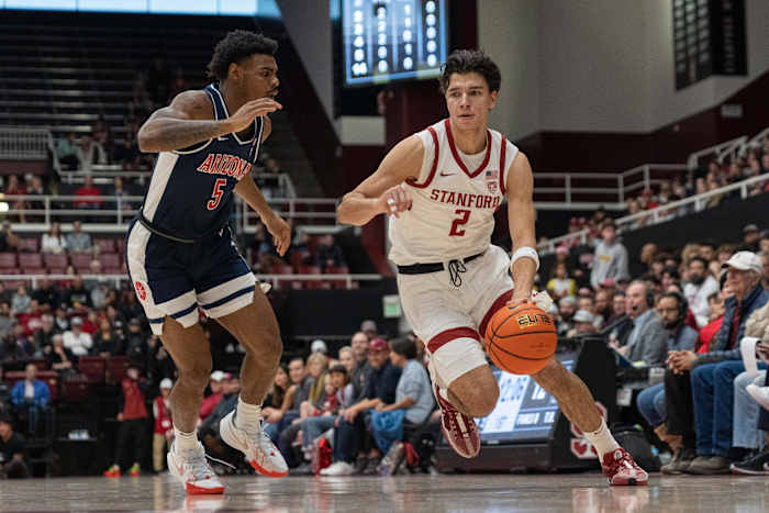 Dec 31, 2023; Stanford, California, USA; Stanford Cardinal guard Andrej Stojakovic (2) attempts to drive around Arizona Wildcats guard KJ Lewis (5) during the first half at Maples Pavilion. Mandatory Credit: Stan Szeto-USA TODAY Spor