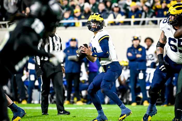 Michigan's J.J. McCarthy looks to throw against Michigan State during the second quarter on Saturday, Oct. 21, 2023, at Spartan Stadium in East Lansing.  