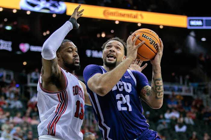 Mar 14, 2024; Kansas City, MO, USA; TCU Horned Frogs forward JaKobe Coles (21) drives to the basket around Houston Cougars forward J'Wan Roberts (13) during the second half at T-Mobile Center.