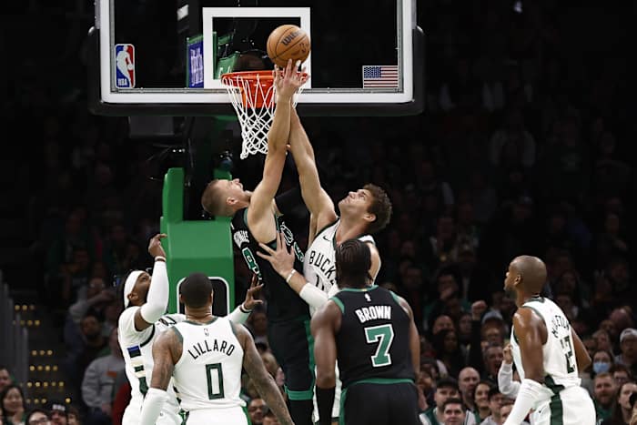 Boston Celtics center Kristaps Porzingis (8) and Milwaukee Bucks center Brook Lopez (11) 