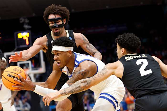 Dayton, OH, USA; Boise State Broncos guard Chibuzo Agbo (11) controls the ball pressured by Colorado Buffaloes guard J'Vonne Hadley (1) and guard KJ Simpson (2) in the first half at UD Arena