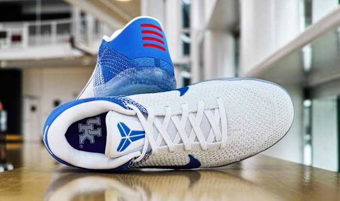 Side view of Kentucky-branded Nike Kobe shoes.