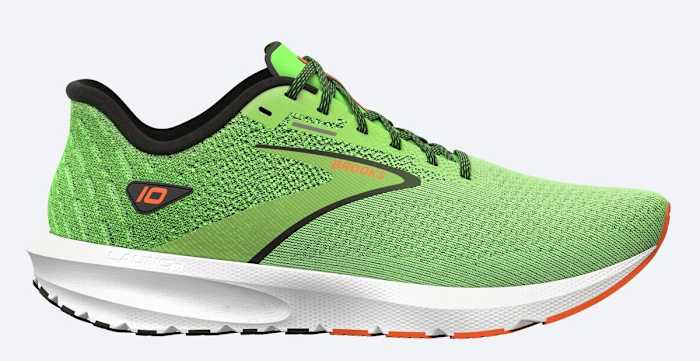 Side view of a green and white Brooks running shoe.