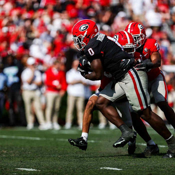 Georgia freshman RB Roderick Robinson (0) carries tacklers on a run during Georgia's spring game in April 2023.
