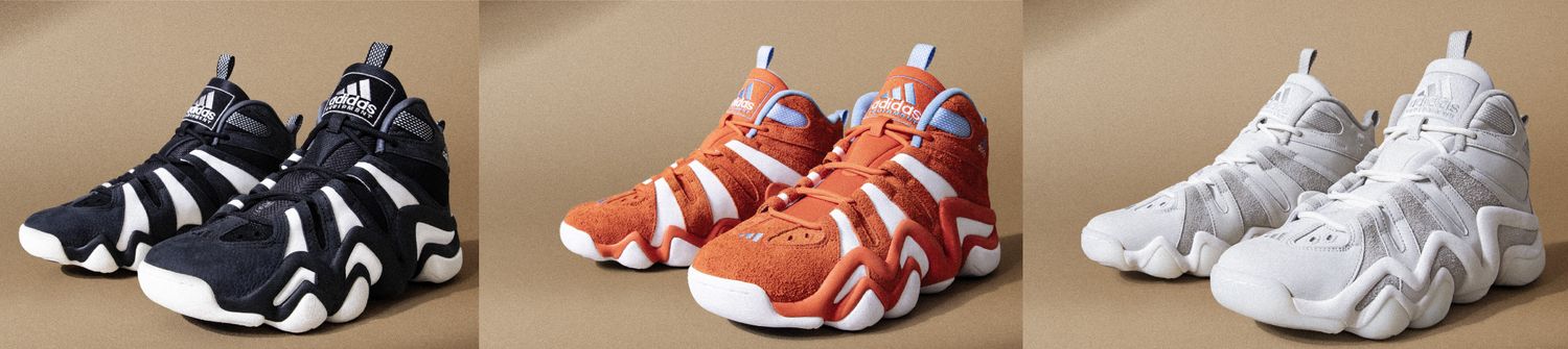 Side view of three multi-color adidas basketball sneakers.