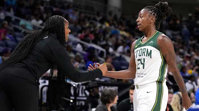 Seattle Storm coach Noelle Quinn welcomes Jewell Loyd back to the bench during the second half of the team's WNBA basketball game against the Chicago Sky.