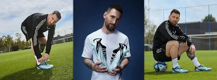 Lionel Messi models blue and black adidas soccer shoes.