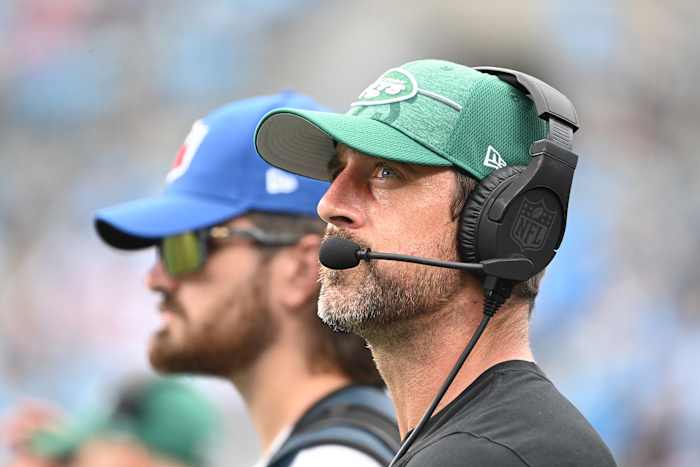 QB Aaron Rodgers wears a headset during NFL Preseason game in Carolina