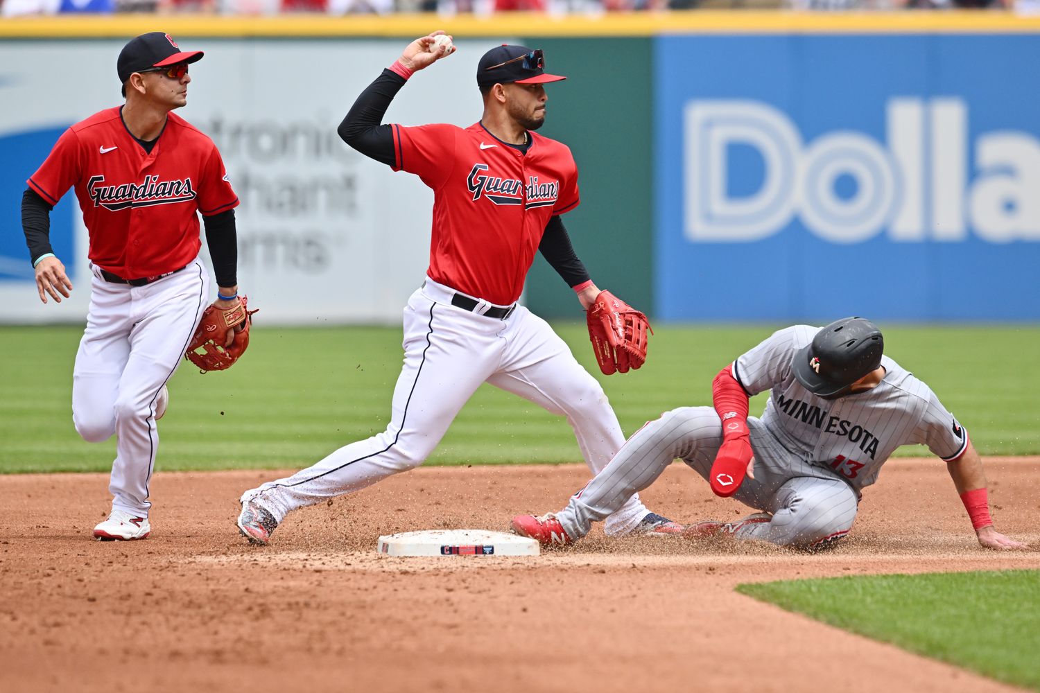 May 7, 2023; Cleveland, Ohio, USA; Cleveland Guardians shortstop Gabriel Arias (13) forces out Minnesota Twins left fielder Joey Gallo (13) and turns the double play as second baseman Andres Gimenez (0) watches during the second inning at Progressive Field. Mandatory Credit: Ken Blaze-USA TODAY Sports